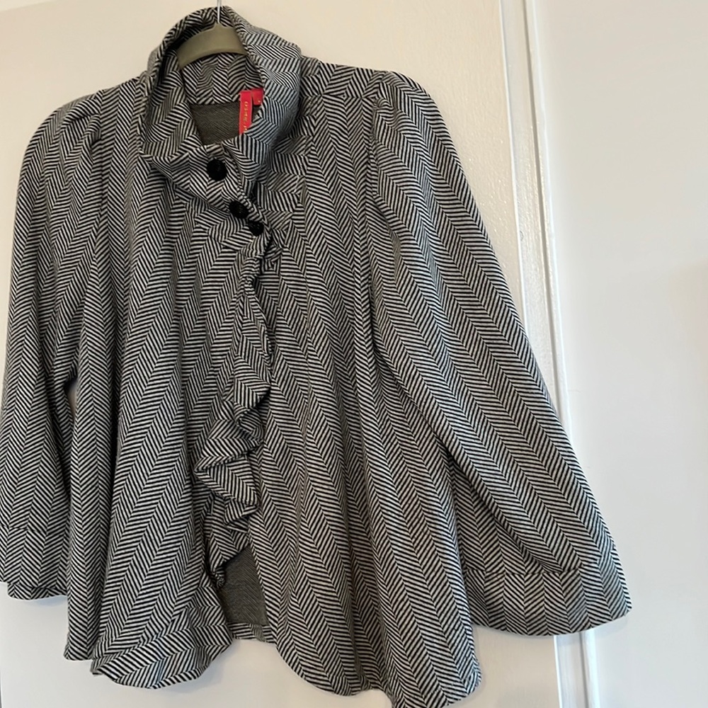 Swing style black-grey cardigan ruffle detail in front quarter length sleeves.